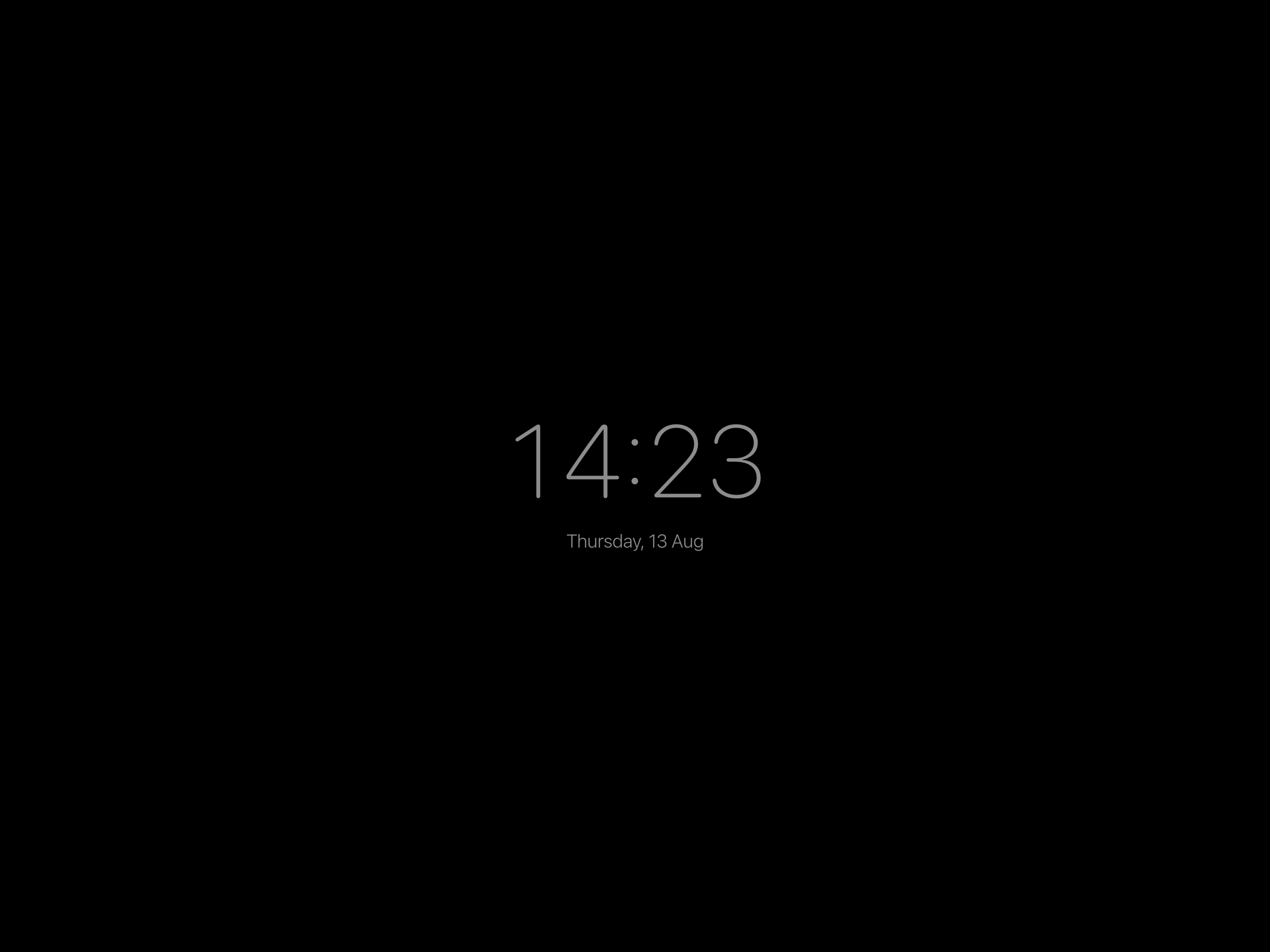 Wallpad's dimmed clock screensaver: a soft grey clock reading 14:23 and the date on a black screen.